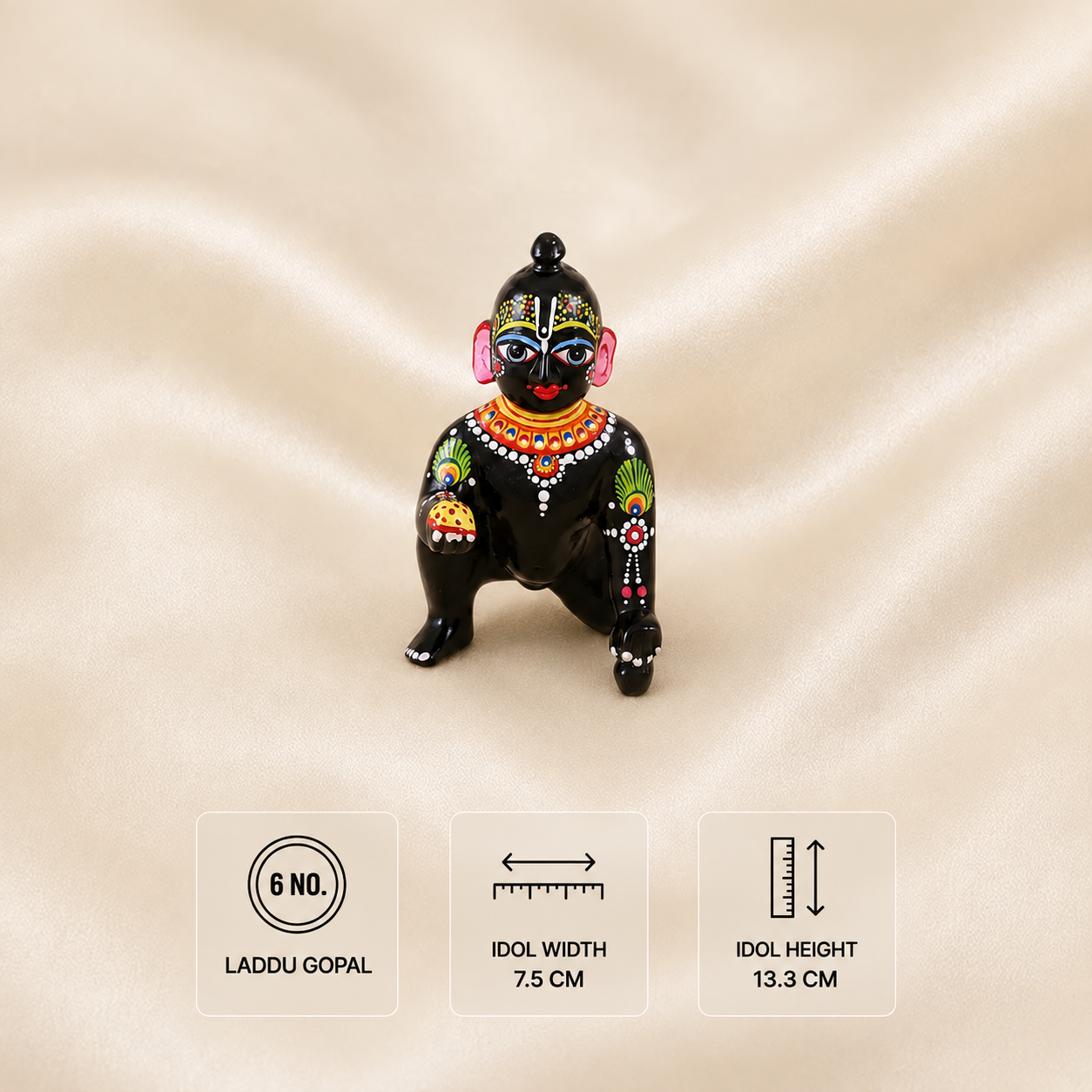 Front view of a black Laddu Gopal idol holding a laddu, 7.5 cm wide and 13.3 cm high.