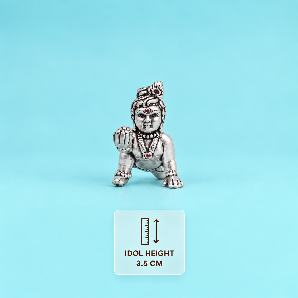 Front view of a silver crawling Laddu Gopal idol holding a sweet, with a card showing its 3.5 cm height.