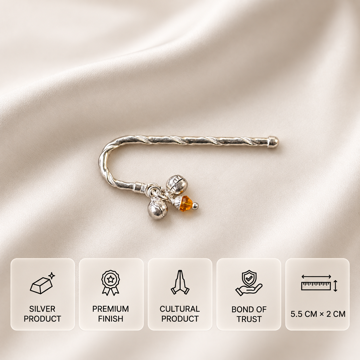 Curved 925 silver flute with two bells and an amber bead on cream satin, with feature cards showing 5.5 × 2 cm dimensions.