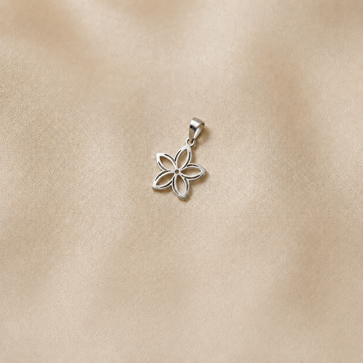 925 silver five-petal flower design pendant measuring 34 x 22 mm on a smooth champagne satin background