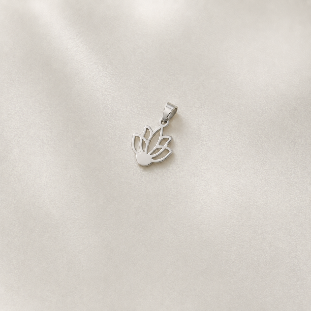925 silver lotus design pendant measuring 34 x 20 mm on a smooth ivory satin background