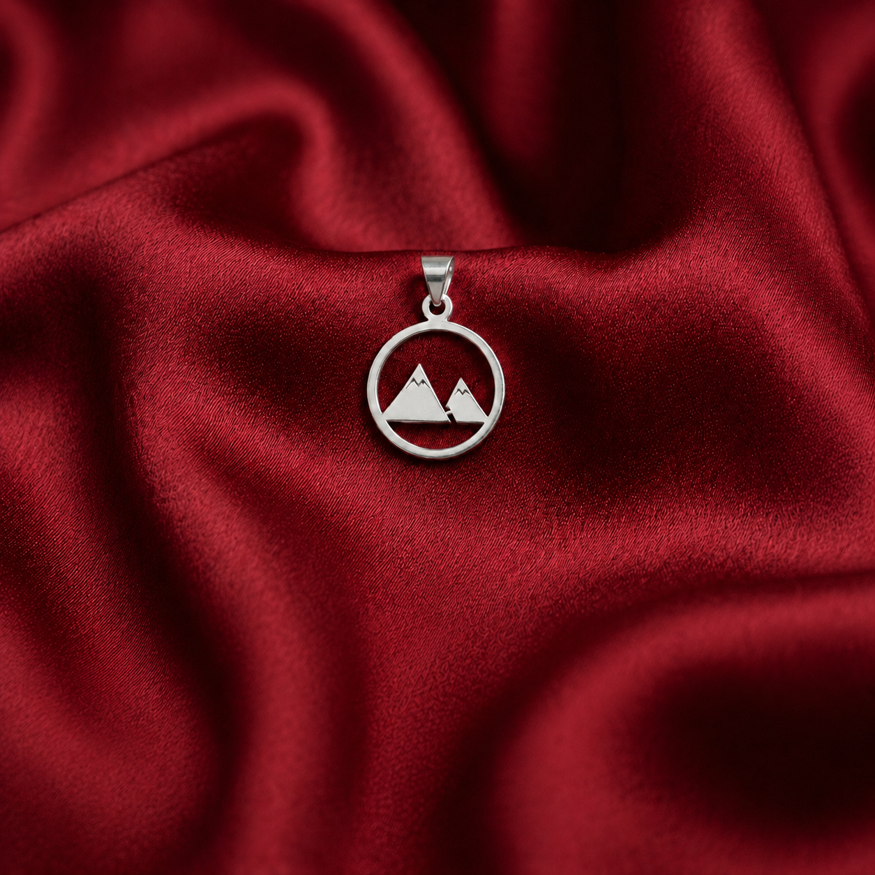 925 silver mountain pendant with two-peak cutout design displayed on ruby-red satin