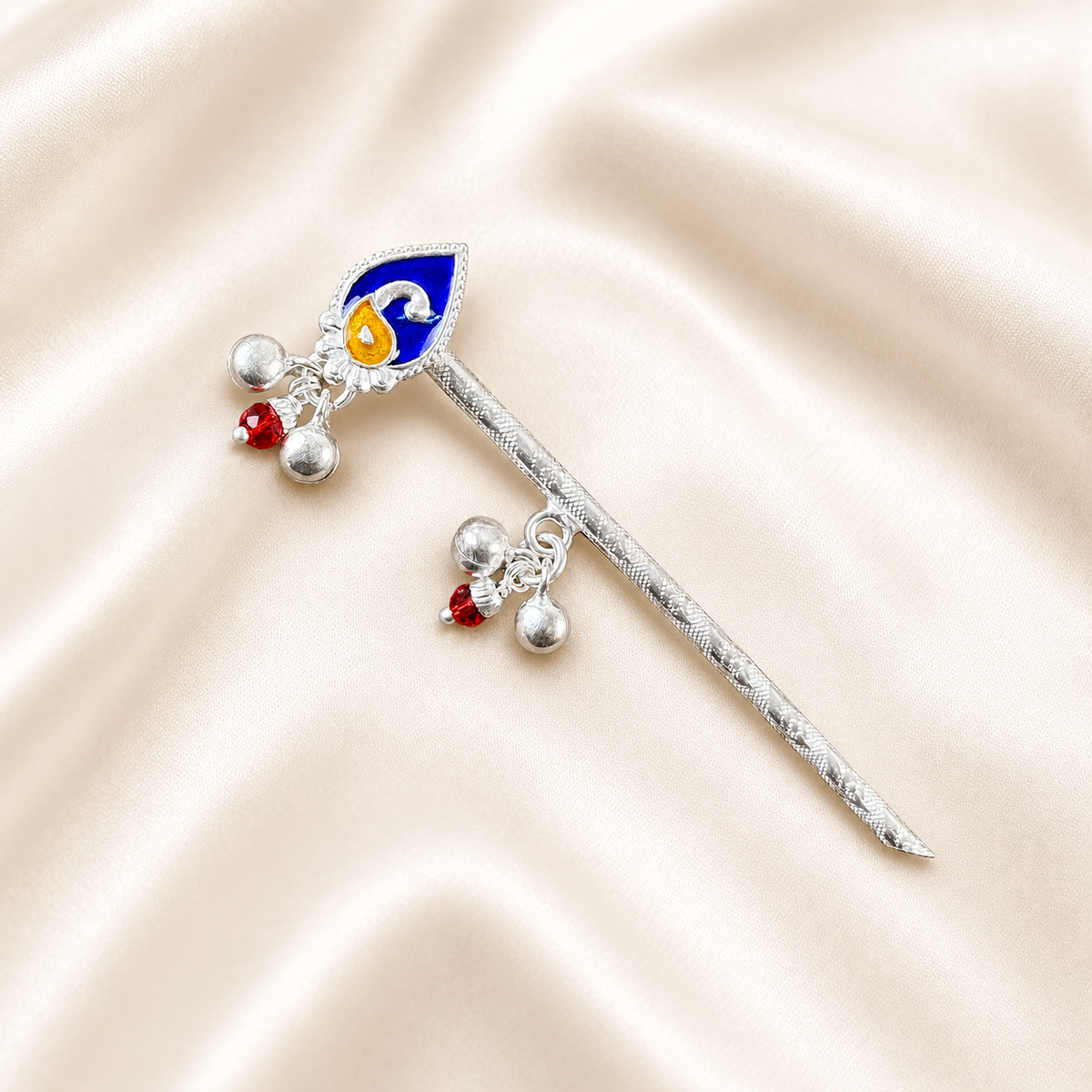 925 Silver flute with a blue and yellow peacock feather design, red beads and four silver bells on cream satin.