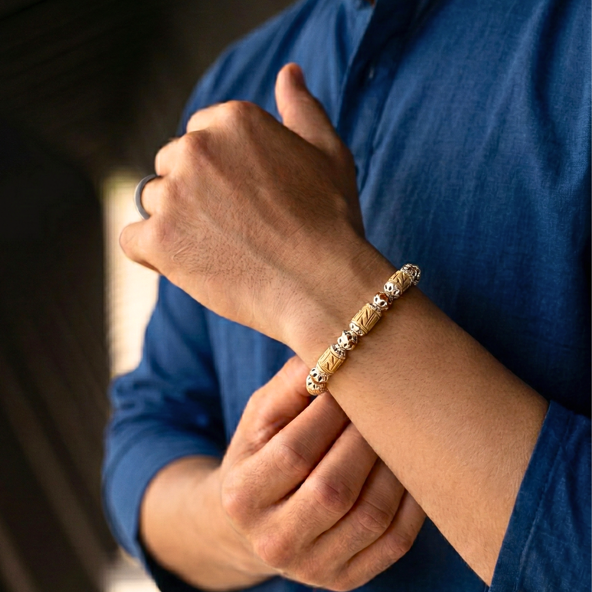 Person wearing a 925 pure silver bracelet featuring alternating Tulsi and Rudraksha beads