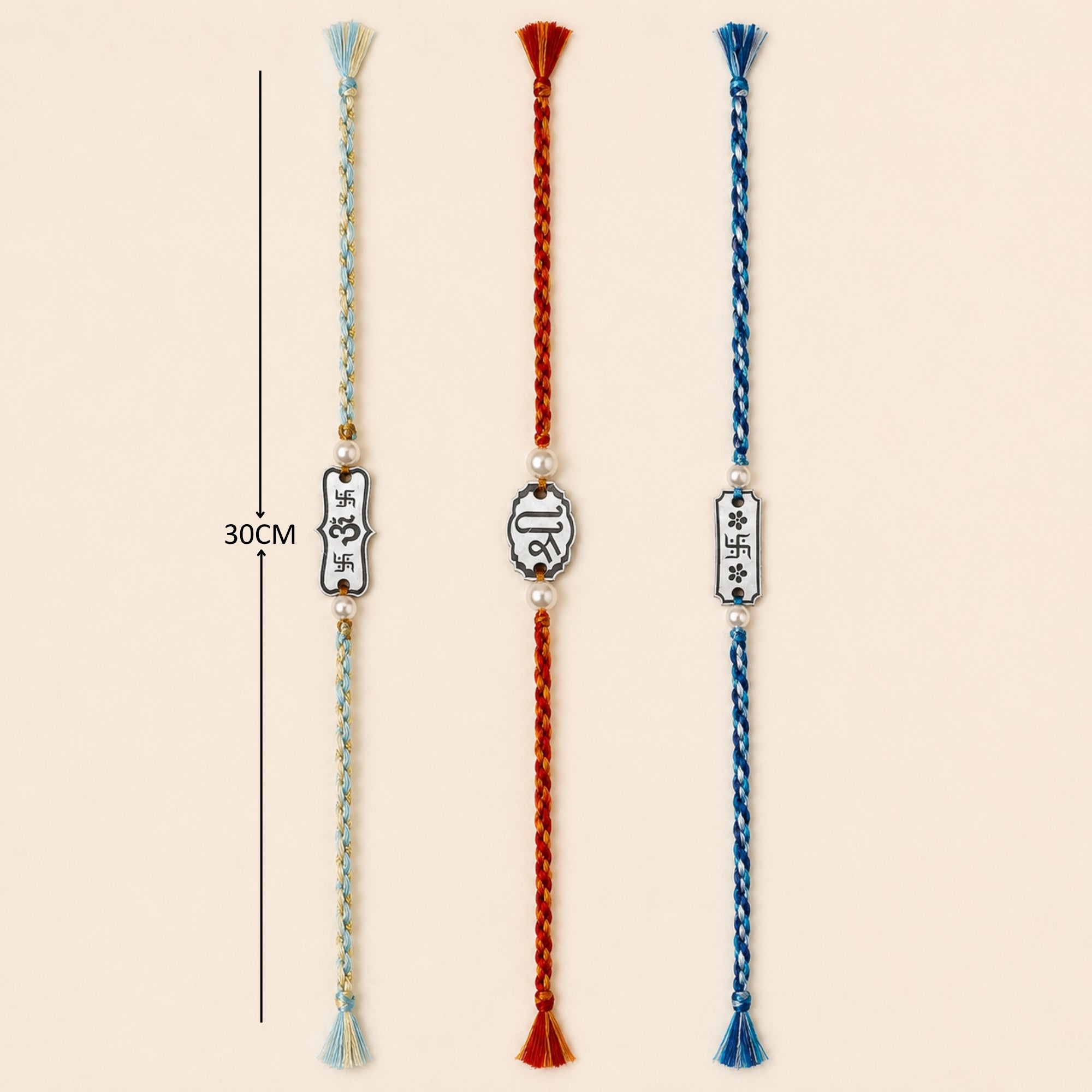 Three 925 sterling silver auspicious charm rakhis with pearl beads laid out vertically