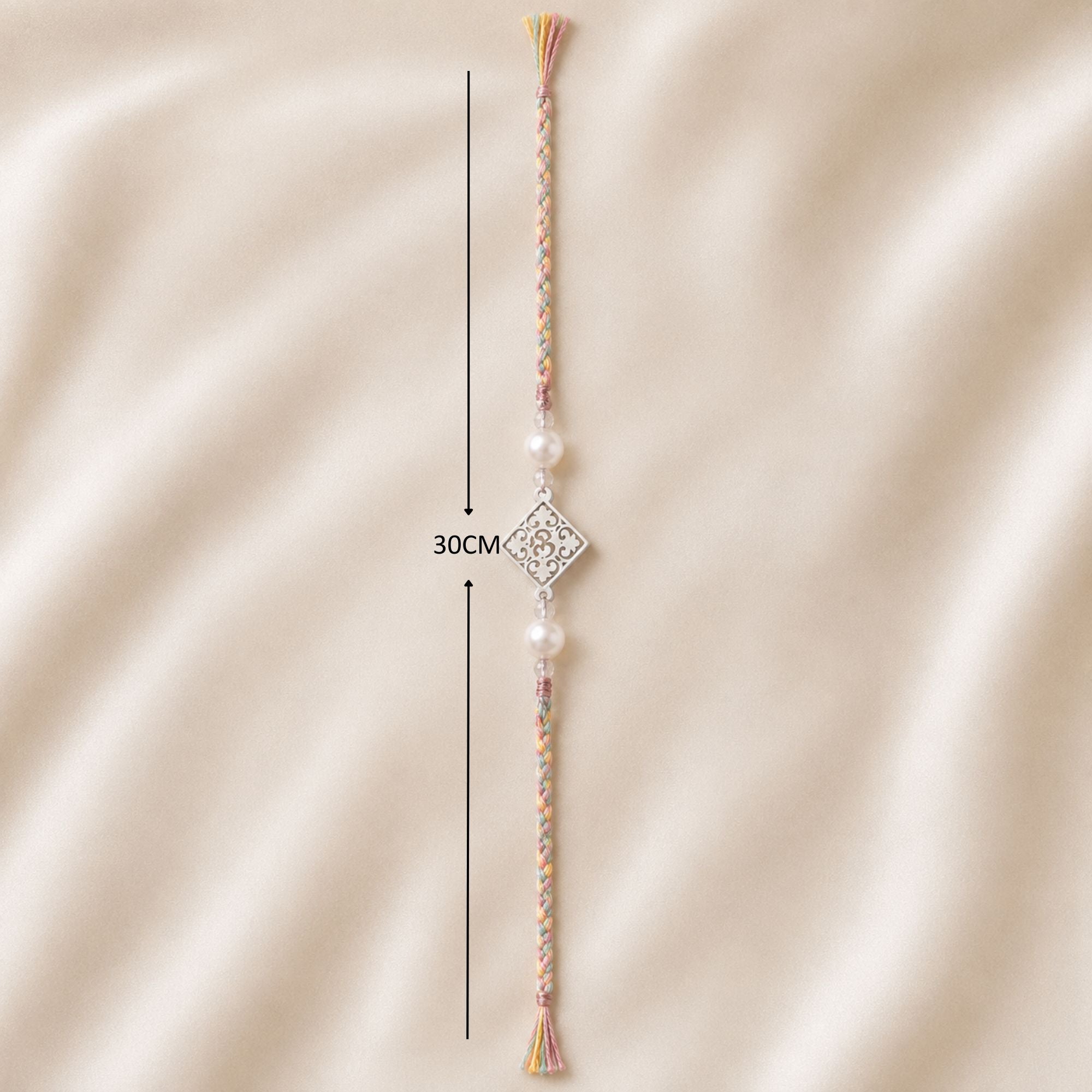 Full length layout showing thread length and dimensions of 925 silver Om filigree rakhi