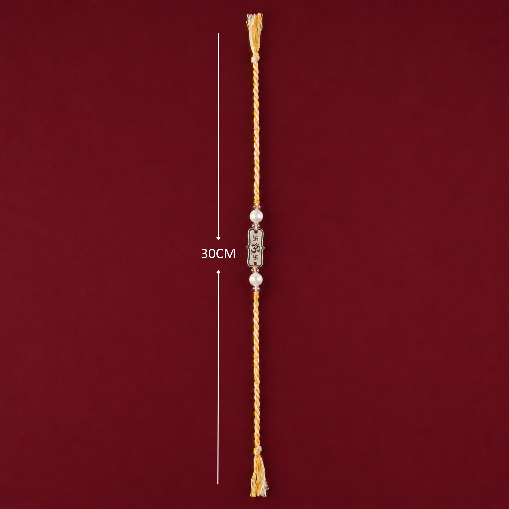 Full length layout showing thread length and dimensions of 925 silver Om Subh Labh frame pearl rakhi