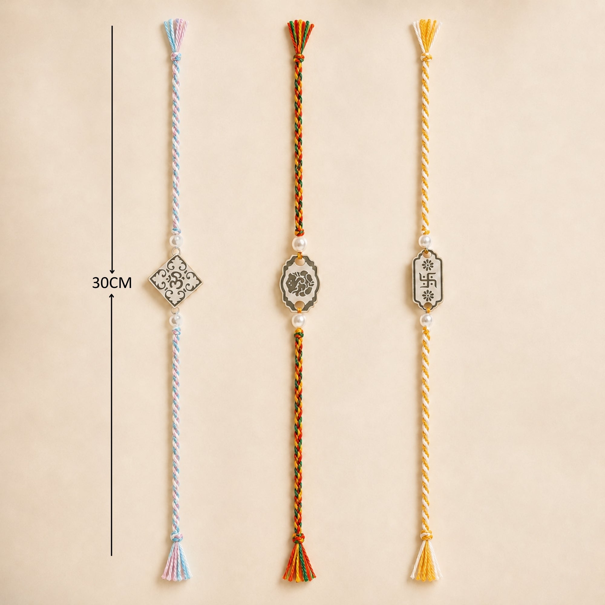 Three 925 sterling silver auspicious symbol charm rakhis with pearl beads laid out vertically