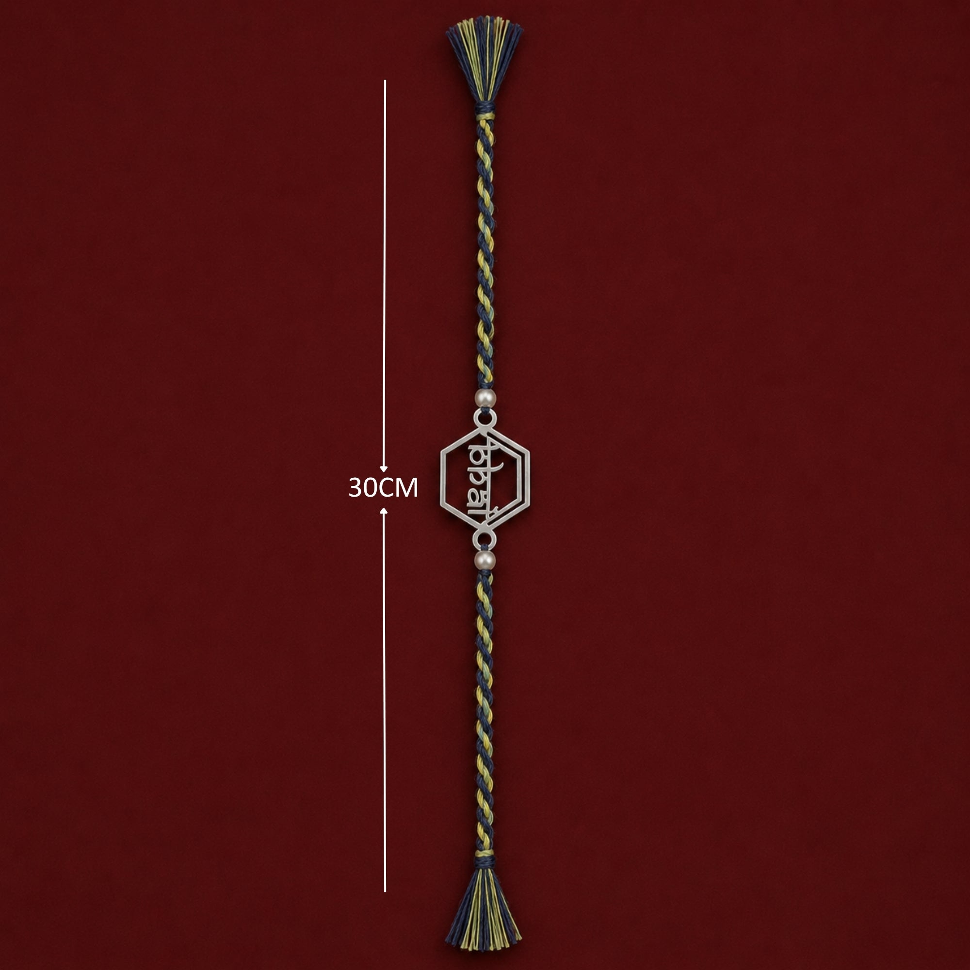 Full length view showing thread layout and tassels of 925 silver Bhai word frame rakhi