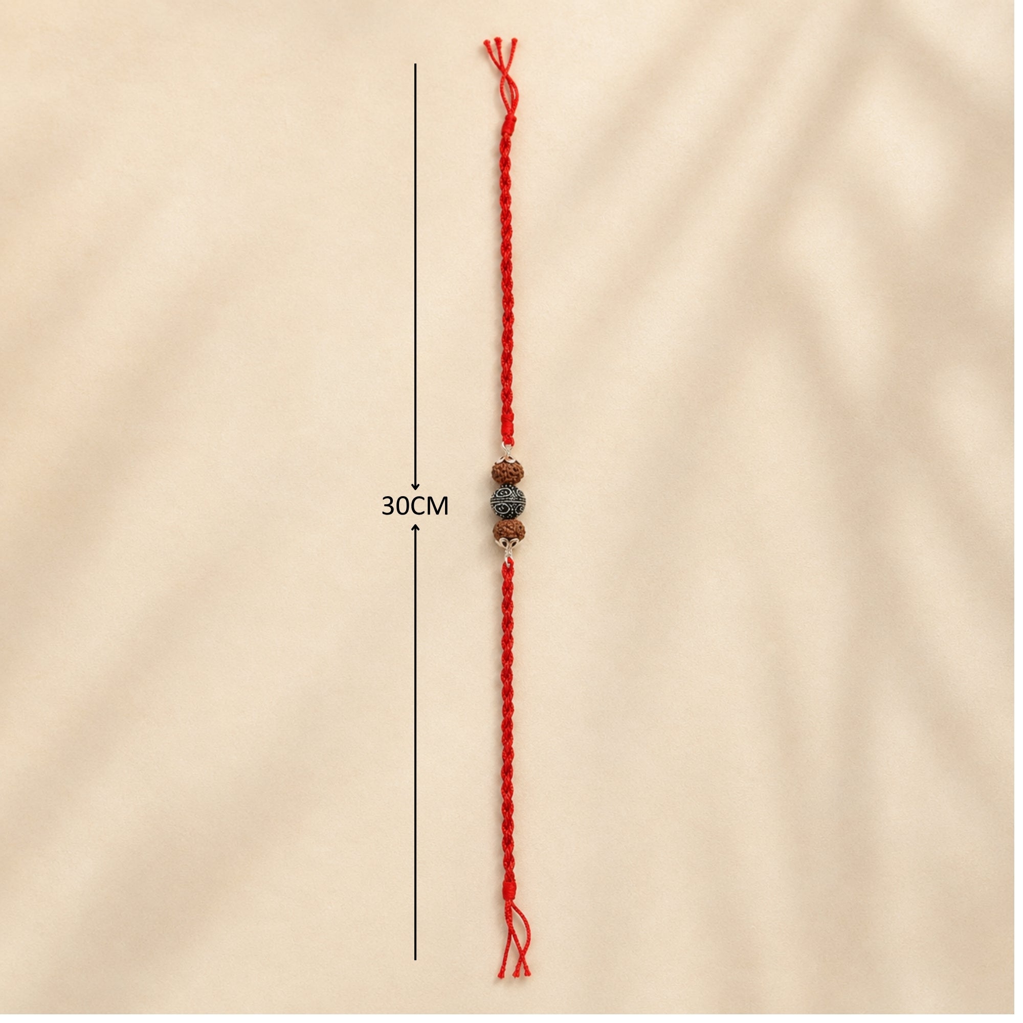 Full length layout showing red thread length and dimensions of 925 silver carved floral Rudraksha rakhi