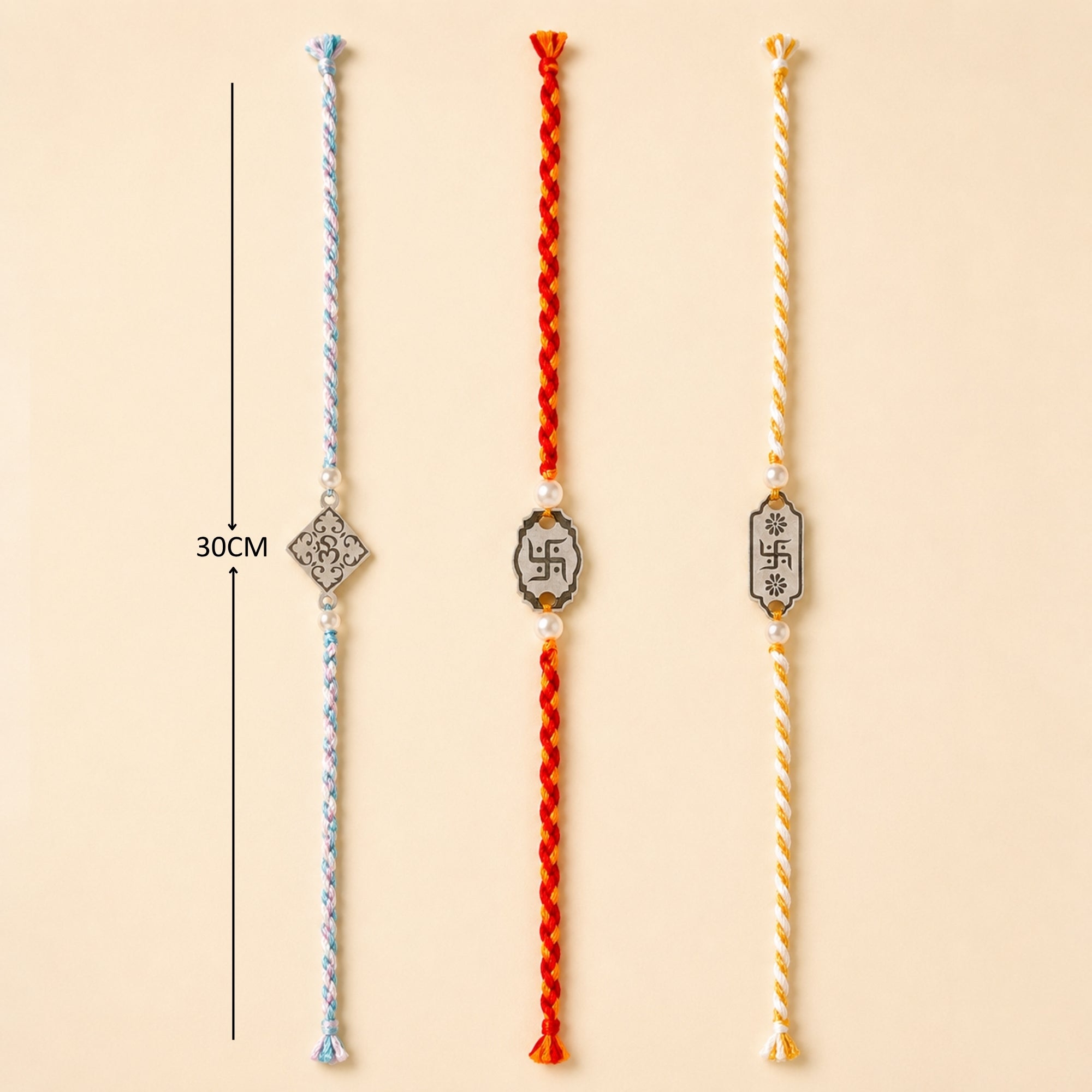 Three 925 sterling silver designer charm rakhis with pearl beads laid out vertically