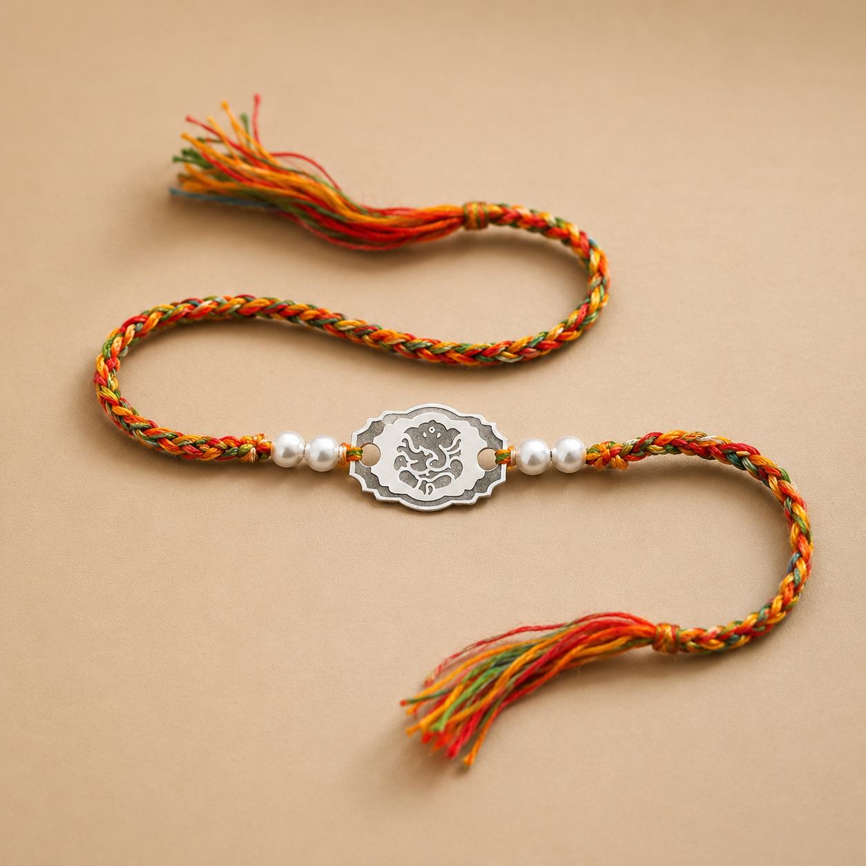 925 pure silver engraved oval Ganesha charm rakhi on red yellow green braided cord
