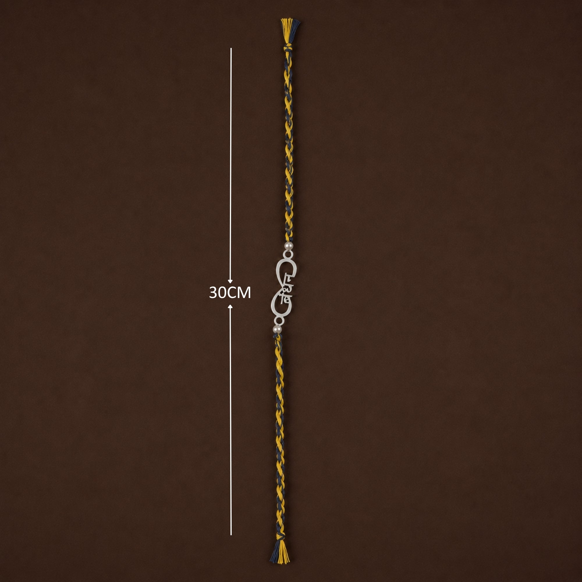 Full length layout showing thread length and tassels of 925 silver infinity Veer rakhi