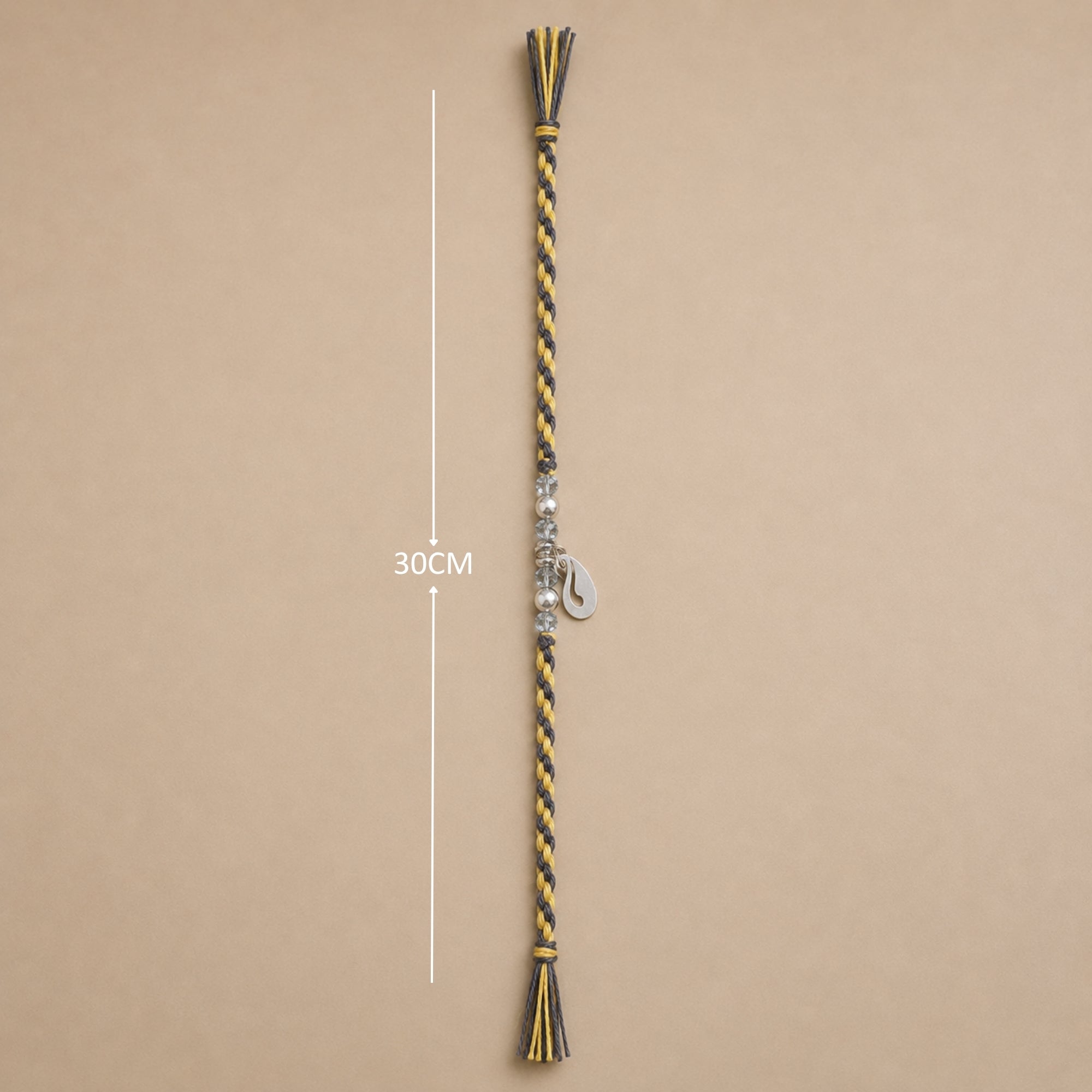 Full length layout of 925 silver peacock rakhi with dual tone cord and tassel ends