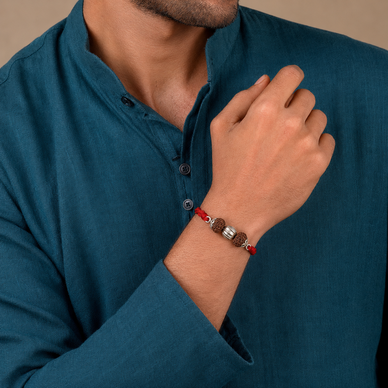 Brother wearing 925 pure silver Rudraksha rakhi bracelet on wrist with dark blue kurta