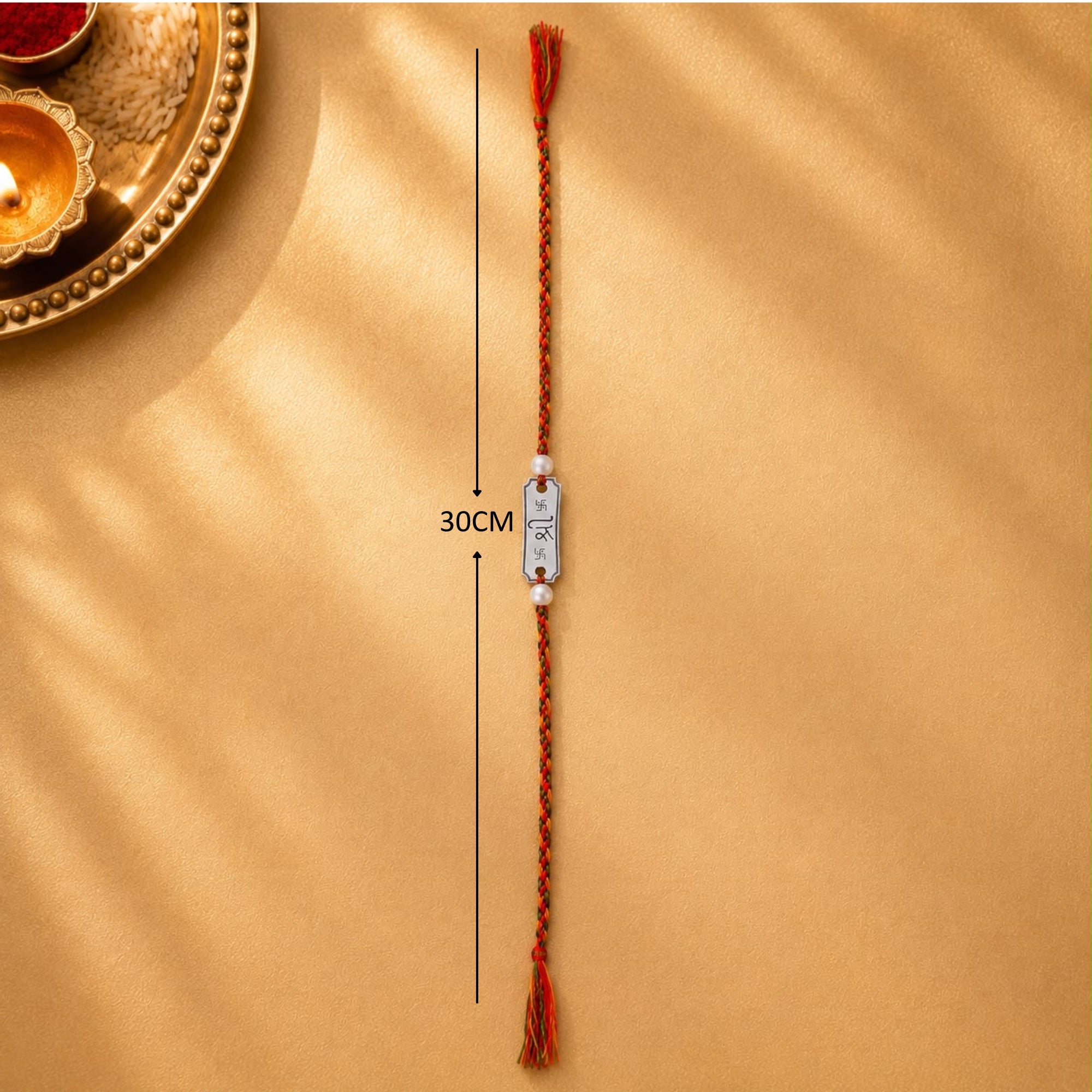 Full length layout showing thread length and dimensions of 925 silver Shree Swastik engraved pearl rakhi