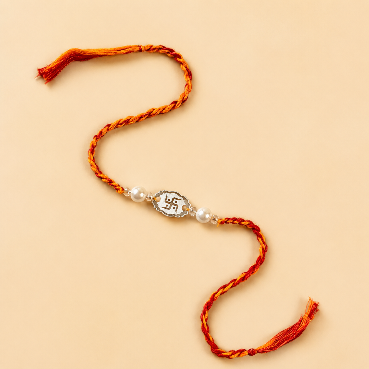 925 pure silver Swastika oval charm rakhi with pearl beads on red and yellow thread