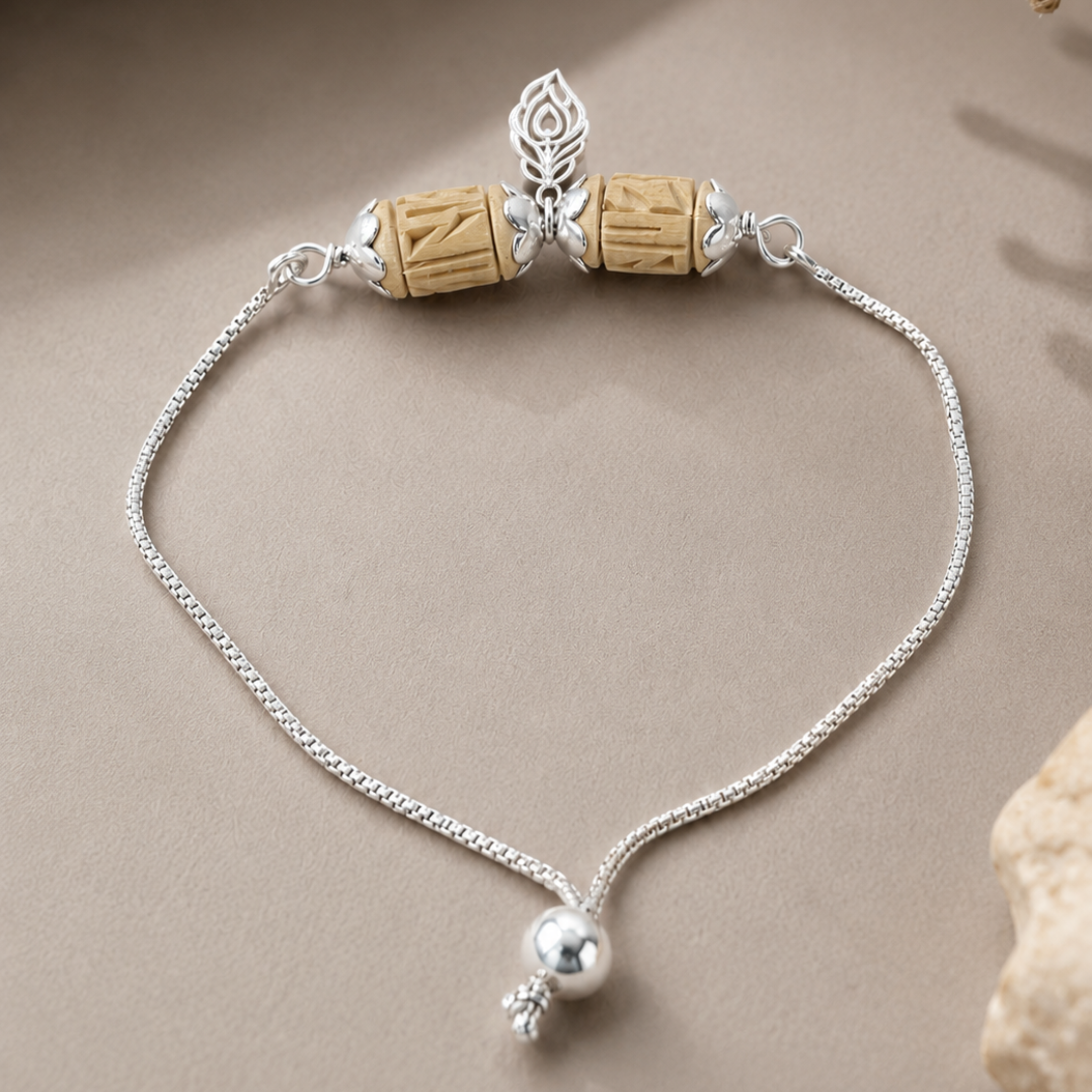 925 sterling silver Tulsi bead chain bracelet with silver caps and charm flat lay view