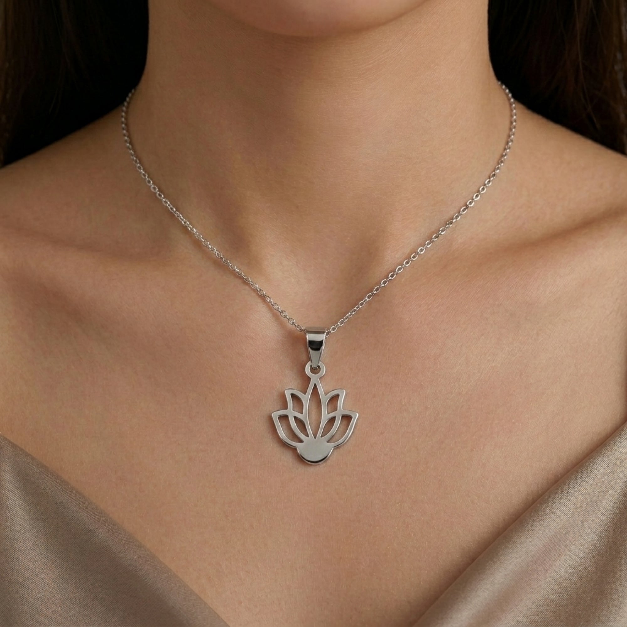 Model wearing 925 sterling silver sacred lotus flower pendant for men and women with champagne silk top