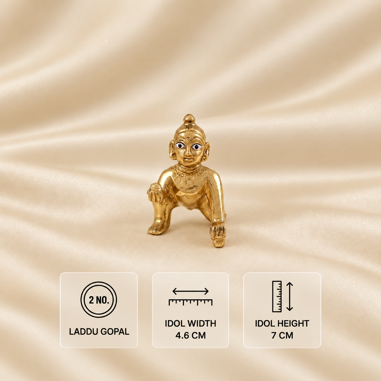 Ashtadhatu crawling Laddu Gopal idol, size 2, measuring 4.6 cm wide and 7 cm high on a cream satin background.