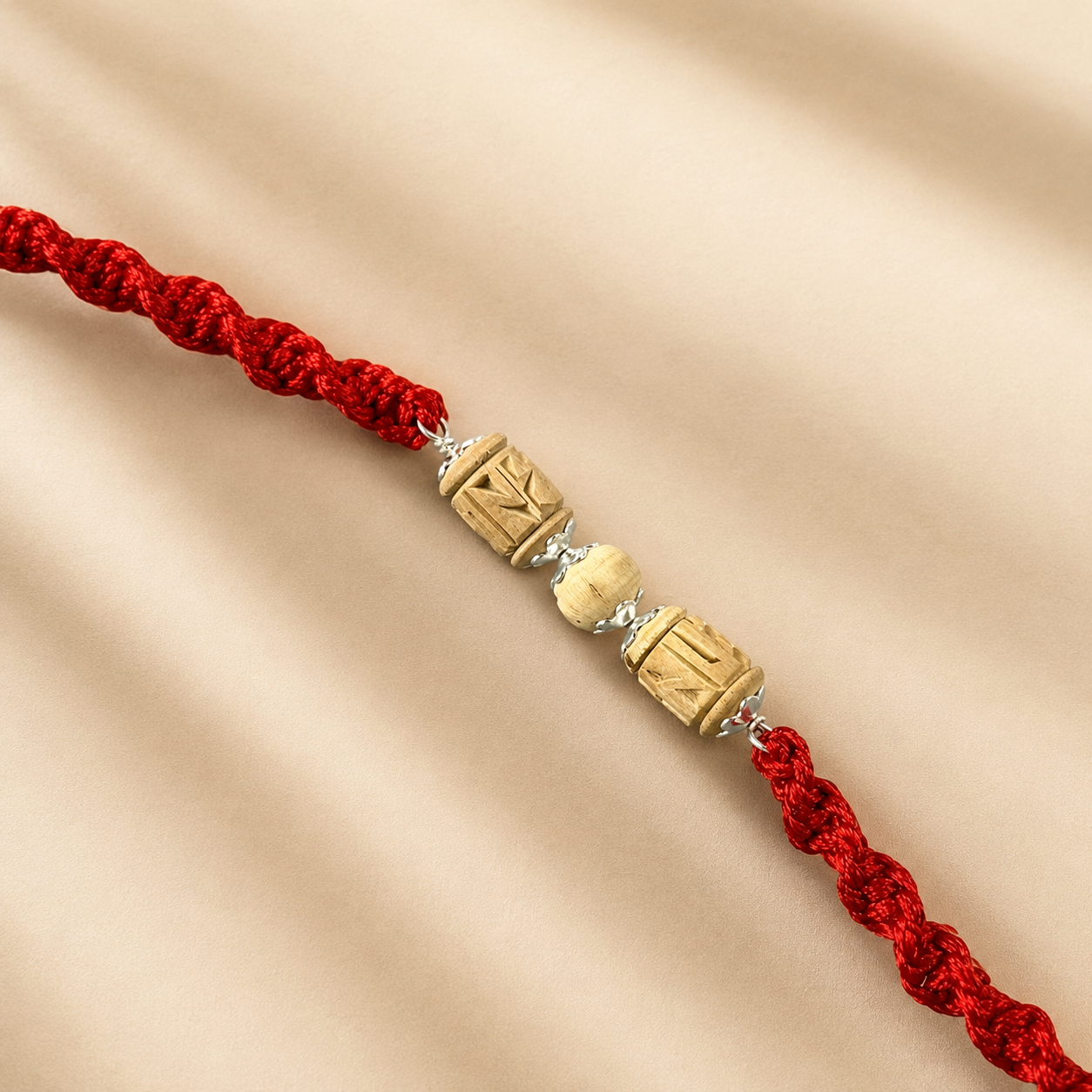 Premium Pure Silver Original Tulsi Rakhi for Brother flat lay display on red braided cord