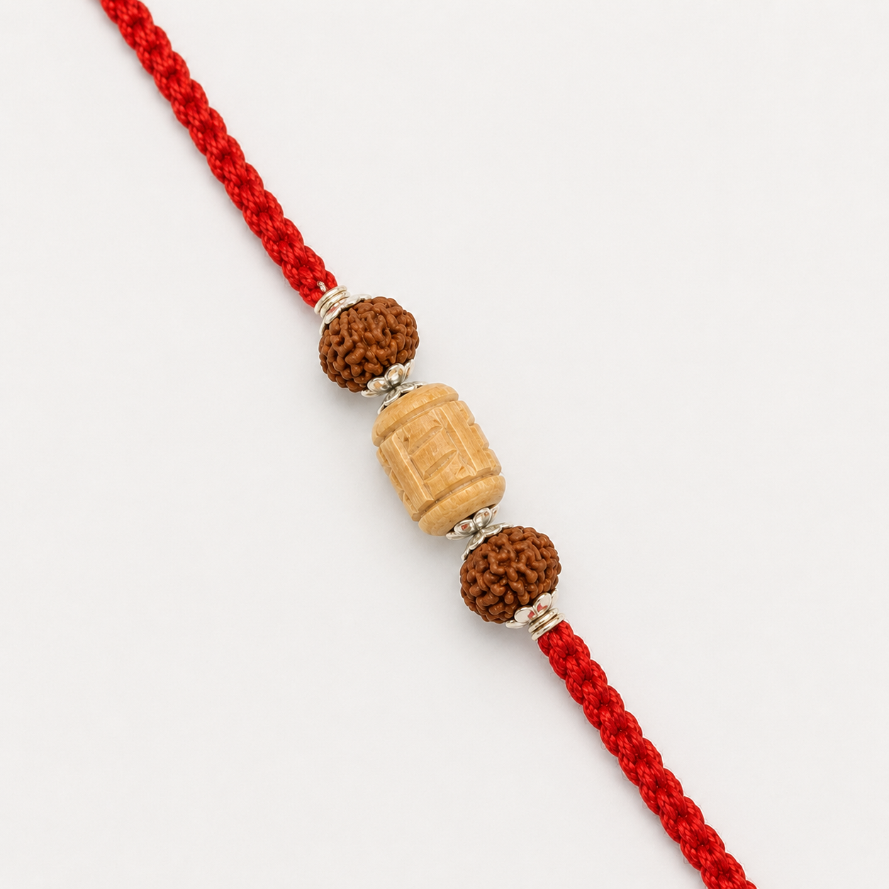 Premium Pure Silver Tulsi Rudraksha Rakhi for Brother flat lay view showing silver caps and red thread