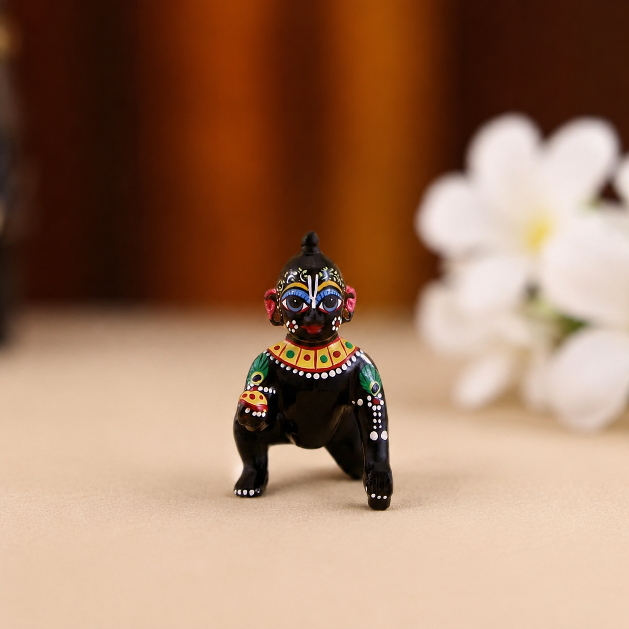 Hand-painted black crawling Laddu Gopal idol with multicolour detailing