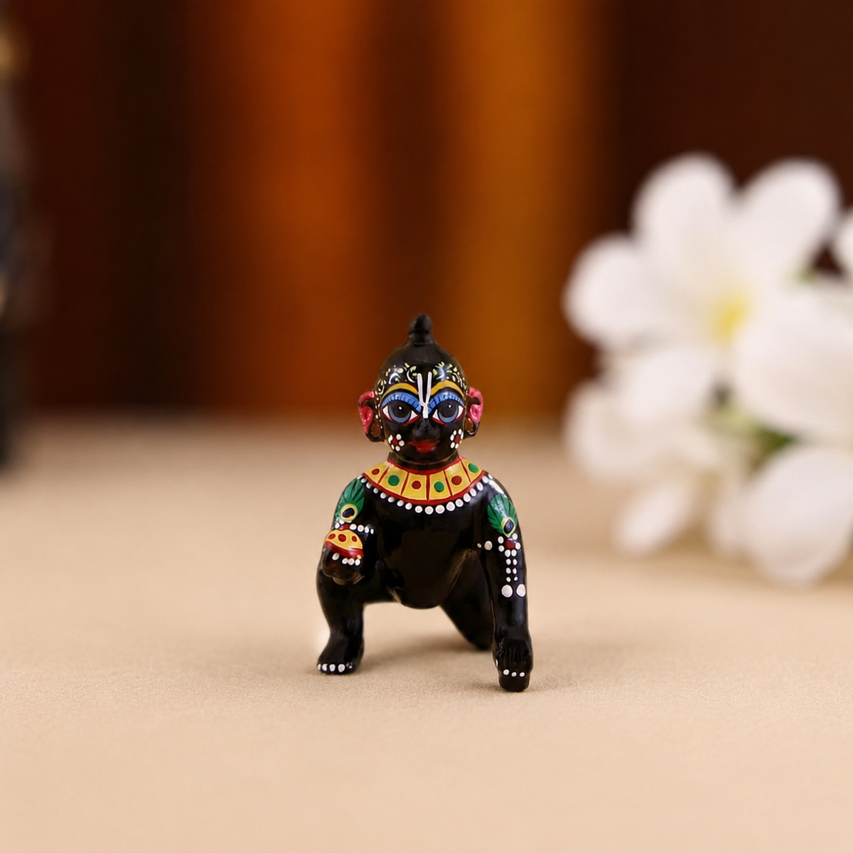 Hand-painted black crawling Laddu Gopal idol with multicolour detailing