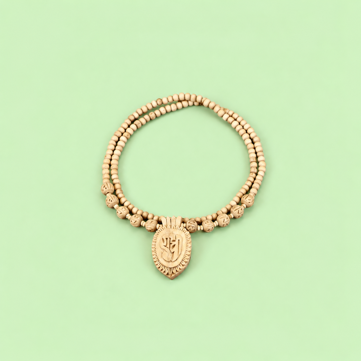 Handcrafted double-strand wooden bead necklace with a carved leaf-shaped pendant