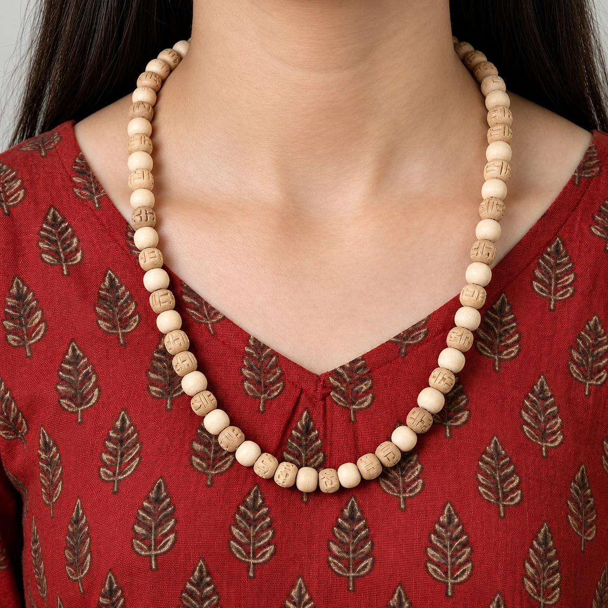 Handcrafted natural wooden bead necklace with smooth and carved beige beads