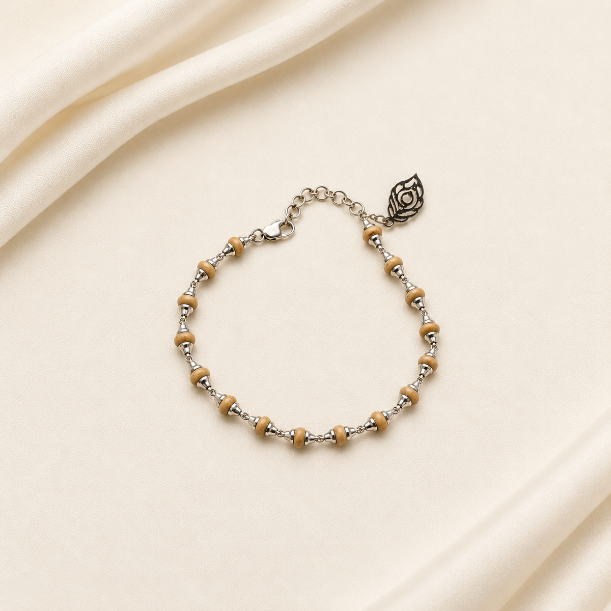 Handcrafted wooden bead bracelet with silver spacers, adjustable chain and leaf-shaped charm