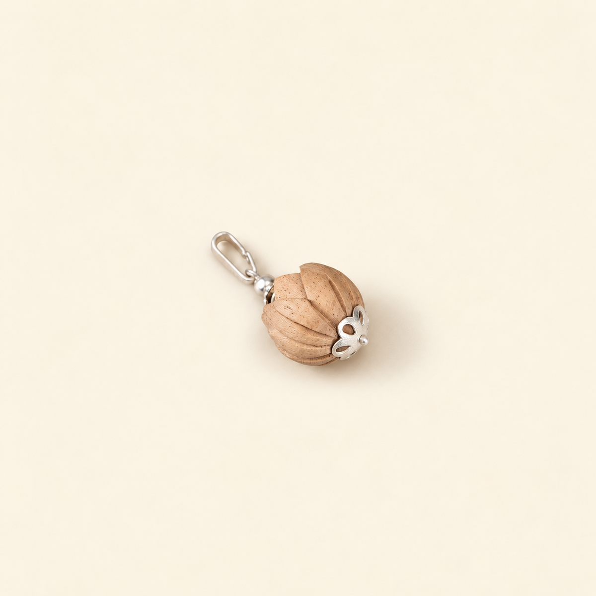 Handcrafted wooden lotus charm with carved petal detailing, silver floral cap
