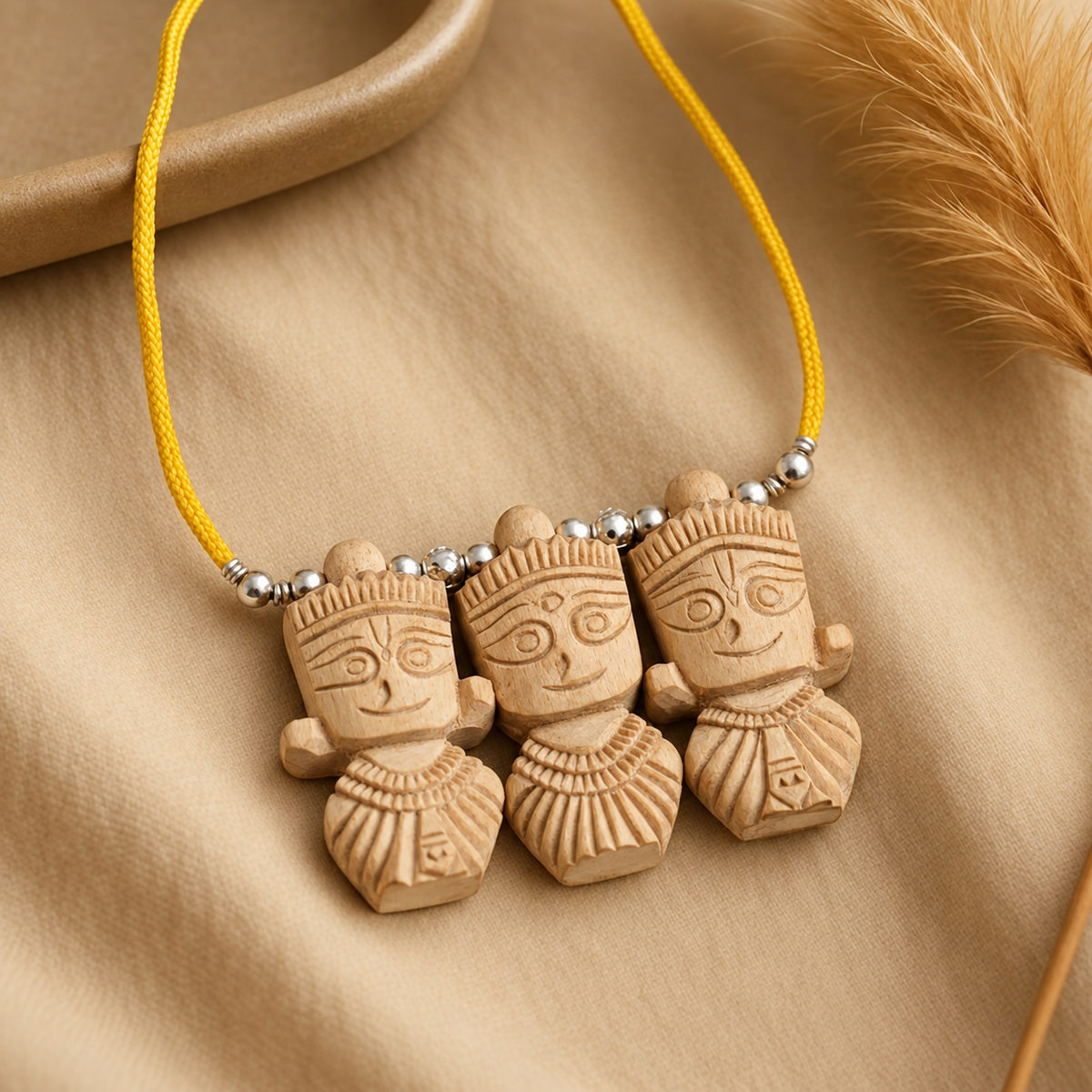 Handcrafted wooden three deity pendant necklace with carved figures, yellow thread and silver beads