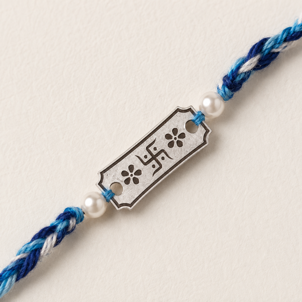 Close-up view of 925 Sterling Silver Swastik Rakhi showing rectangular charm and pearl details