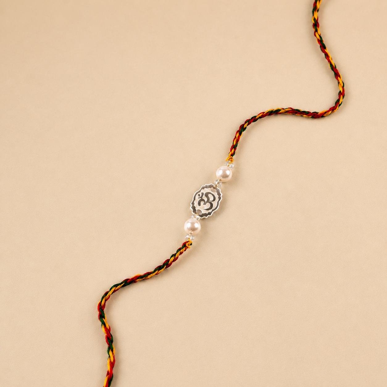 Premium silver Rakhi for brother with engraved silver Om center and pearl beads