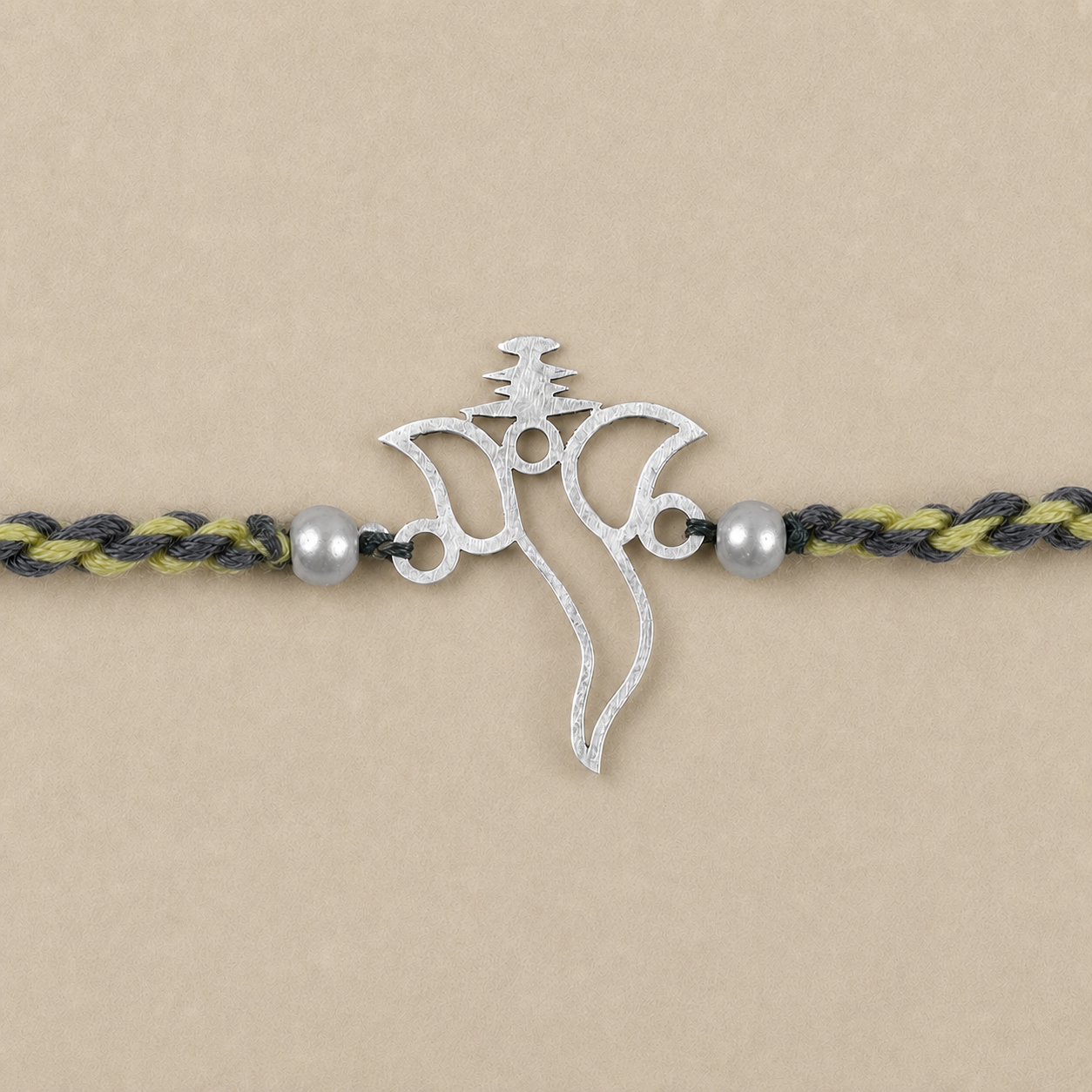 Original Silver Ganesh Rakhi with pearl beads close-up picture