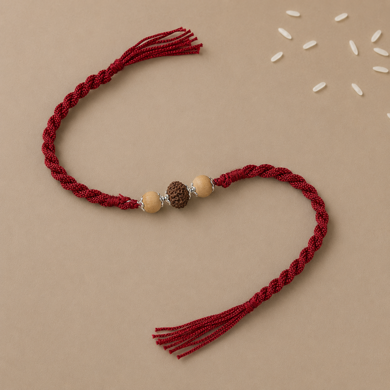 Premium Pure Silver Tulsi Rudraksha Rakhi for Brother flat lay display on red braided thread