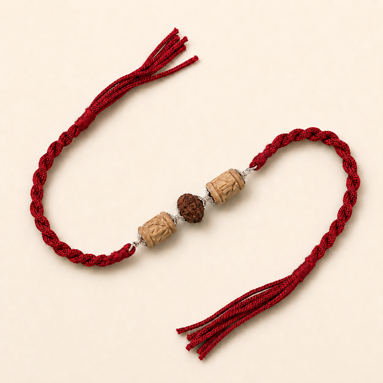 925 Sterling Silver Tulsi Rudraksha Designer Rakhi flat lay display on red braided thread