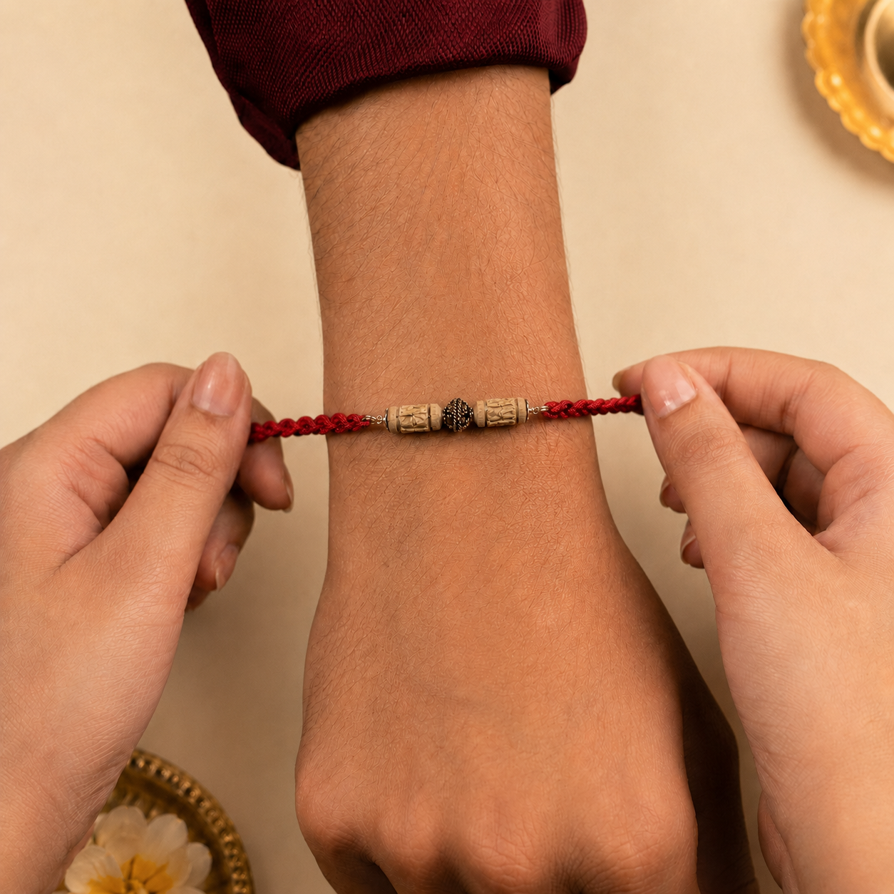 Sister tying handcrafted pure silver Tulsi Rakhi on brother wrist during Raksha Bandhan tying ceremony