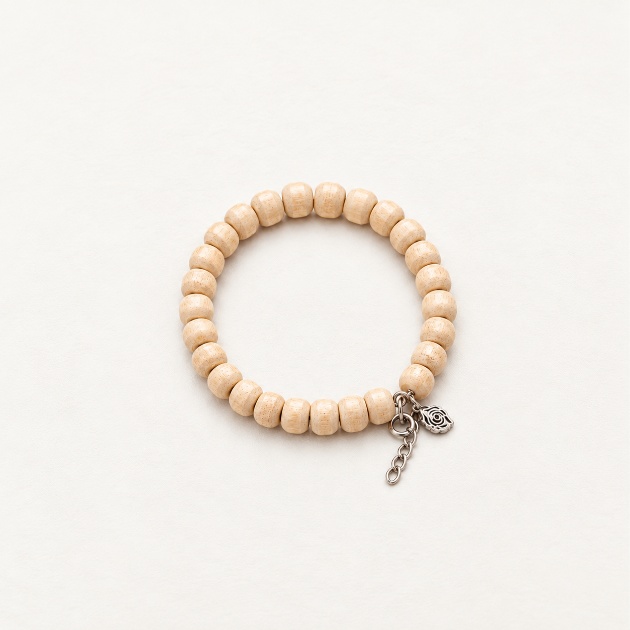 Natural wooden bead bracelet with textured beige beads, silver chain and floral charm