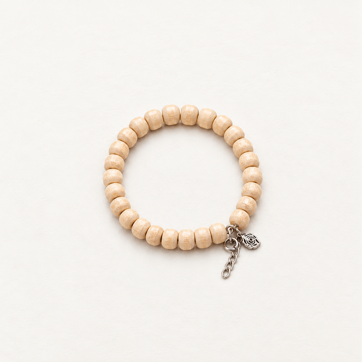 Natural wooden bead bracelet with textured beige beads, silver chain and floral charm