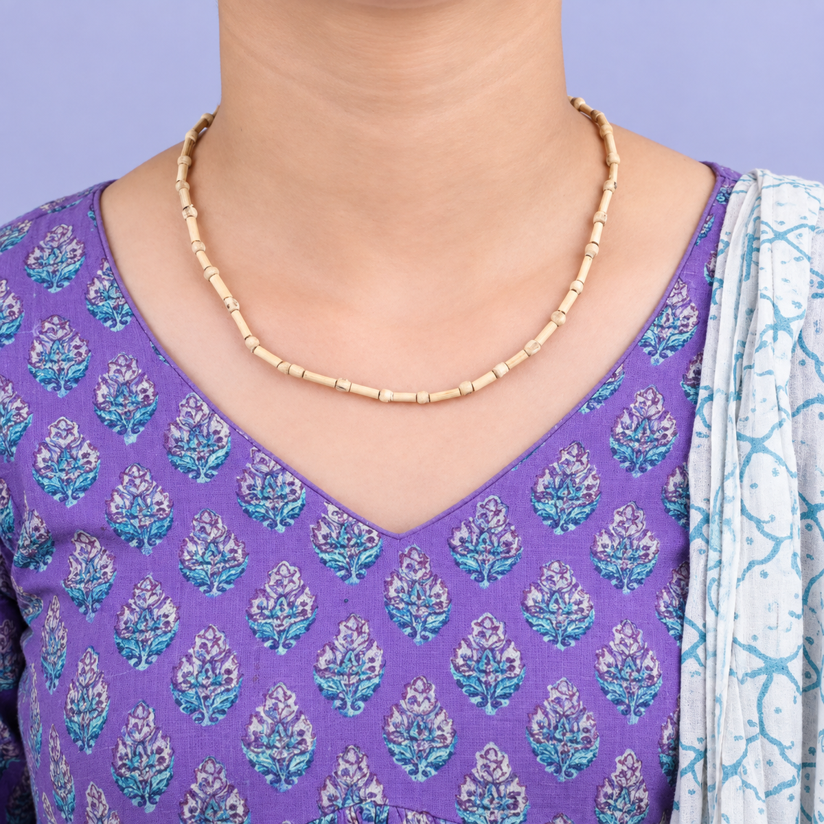 Handcrafted natural wooden bead necklace with slim cream beads worn