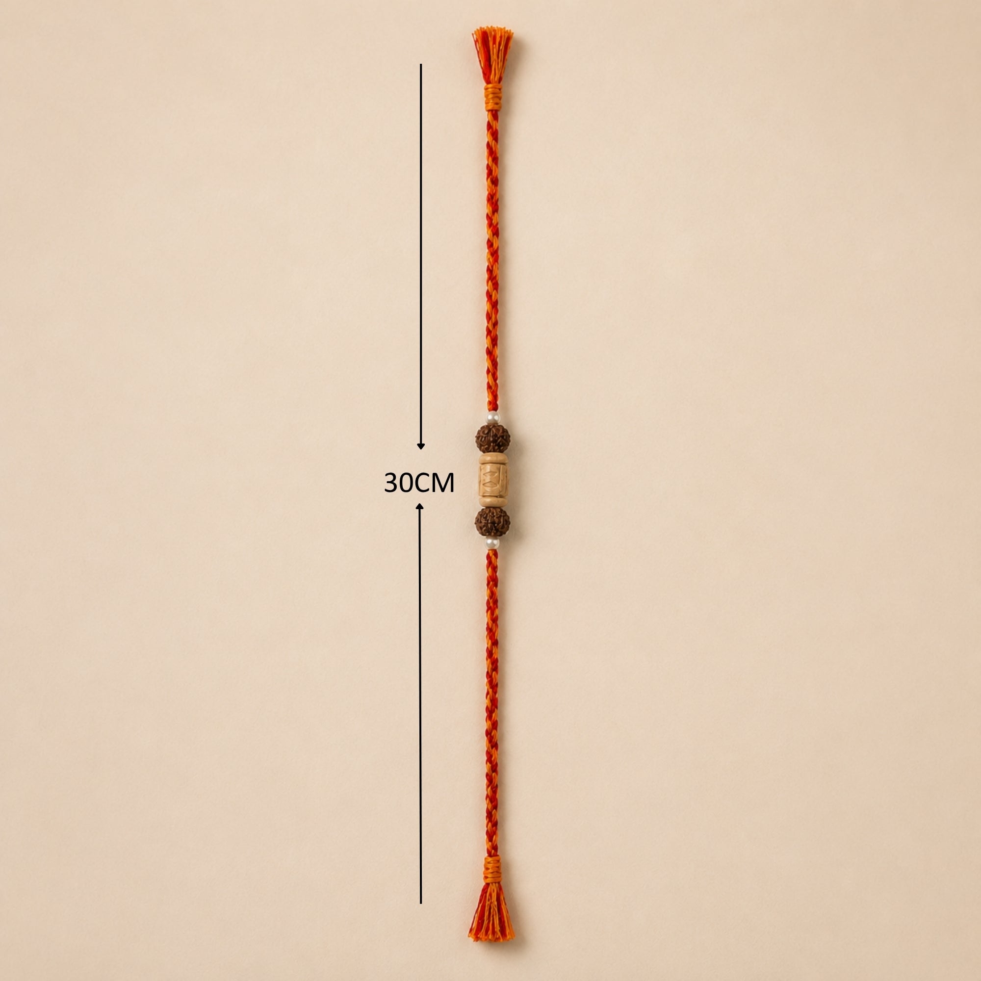 Full length view of handcrafted Tulsi Rudraksha Rakhi thread with red orange tassels