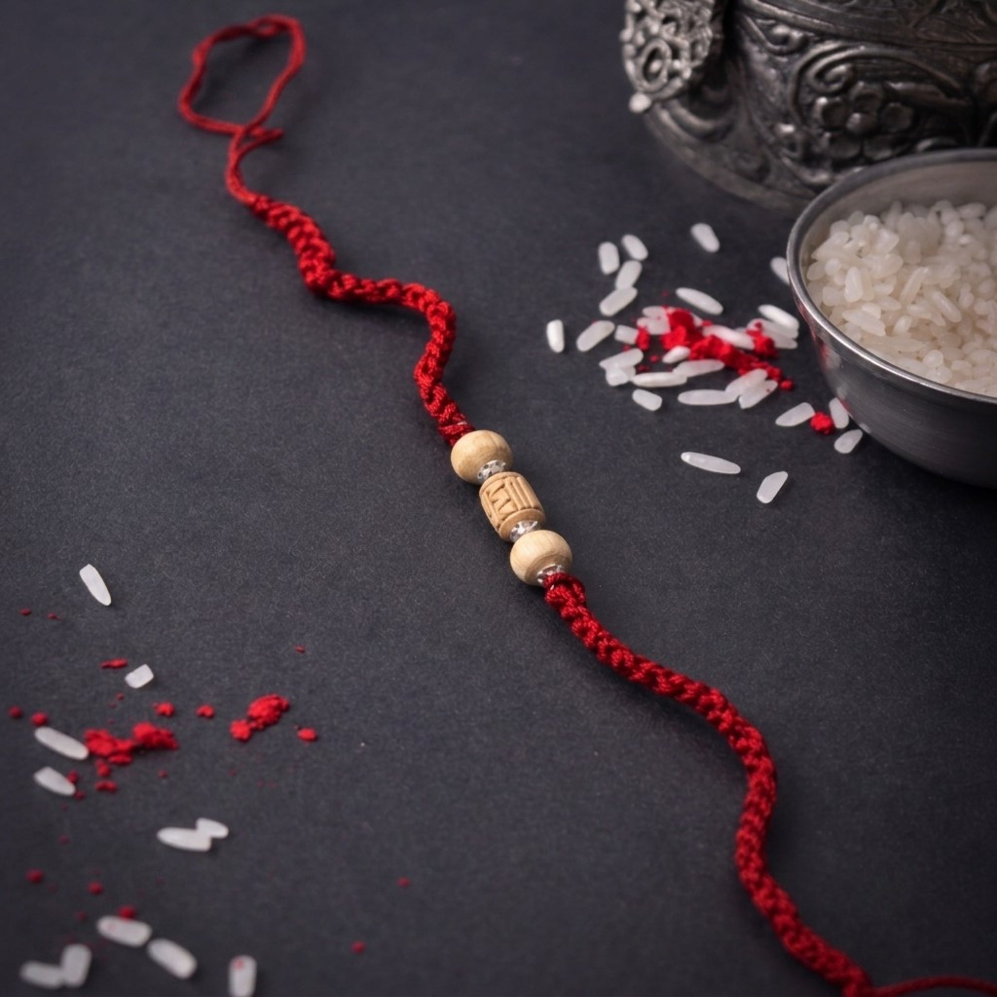 Premium Pure Silver Tulsi Rakhi for Brother flat lay display on red braided cord