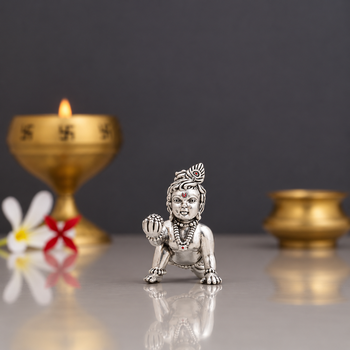Silver Laddu Gopal idol in a crawling pose