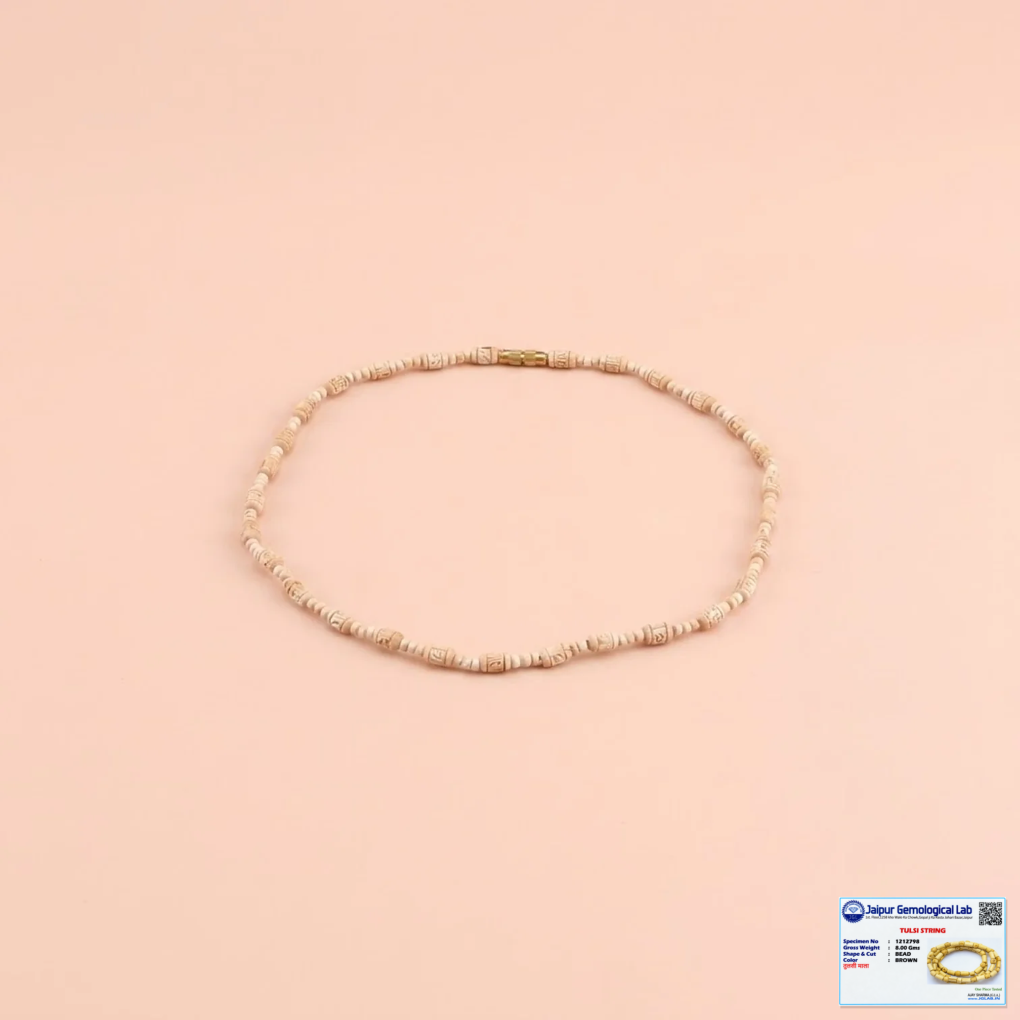 Natural Tulsi bead necklace with a small Jaipur Gemological Lab certificate in the bottom-right corner