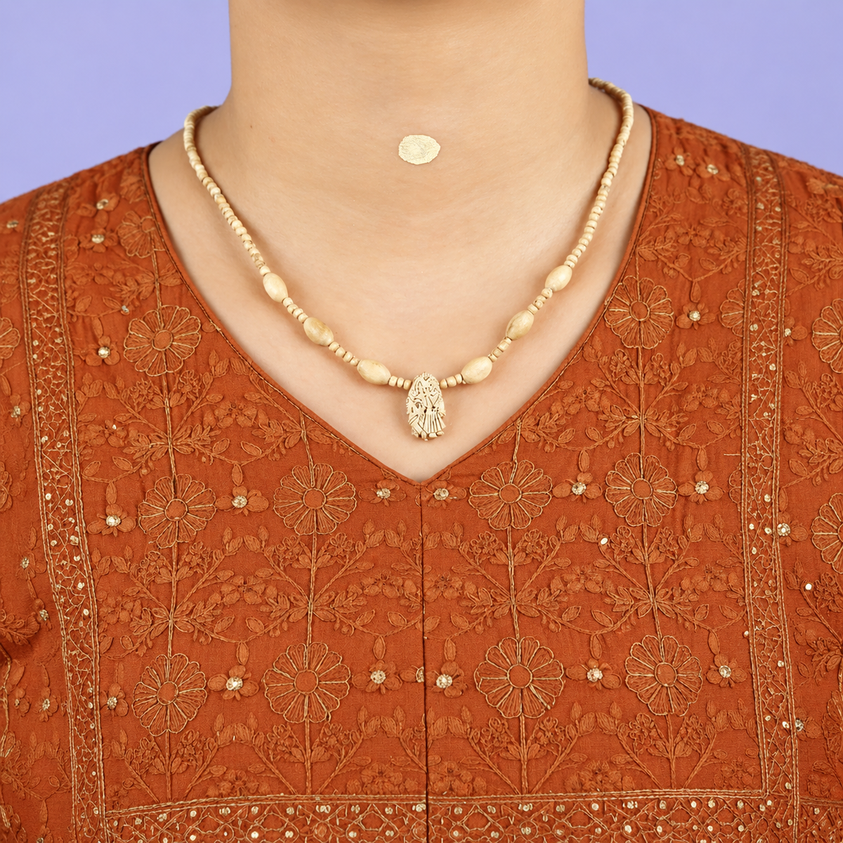 Handcrafted wooden bead necklace with a carved Radha pendant