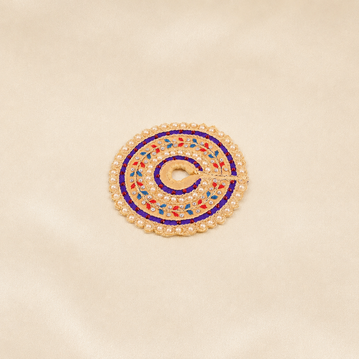 Small beige Laddu Gopal dress with purple bands, pearl border and colourful leaf embroidery
