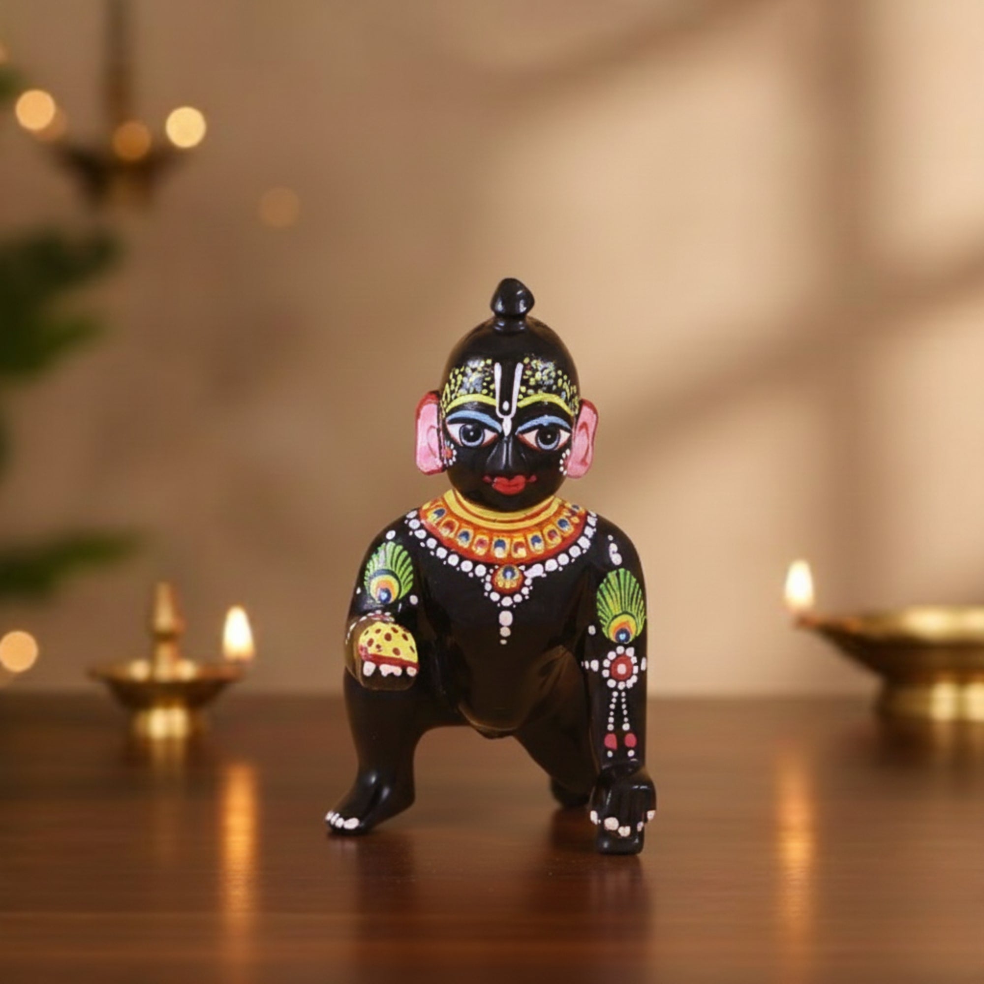 Heavy-weighted black brass Laddu Gopal idol of Thakur Ji with attractive eyes displayed with diyas