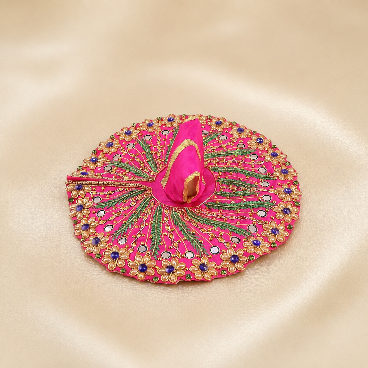 Bright pink Laddu Gopal dress with mirror work, gold floral embroidery, green leaf detailing and purple stones